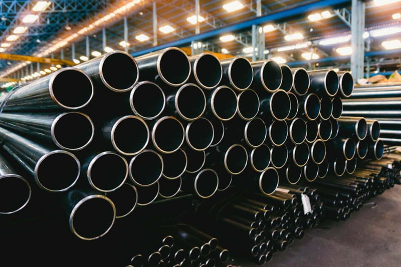 Steel pipes stacked in a warehouse for import and distribution in Indonesia.